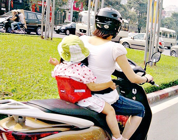 phụ huynh thường cho bé đeo dây đai an toàn khi tham gia giao thông để giúp các bé được bảo vệ an toàn, ngồi ngay ngắn trên xe